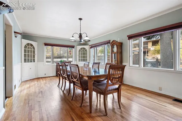 a view of a dining room with furniture wooden floor and chandelier