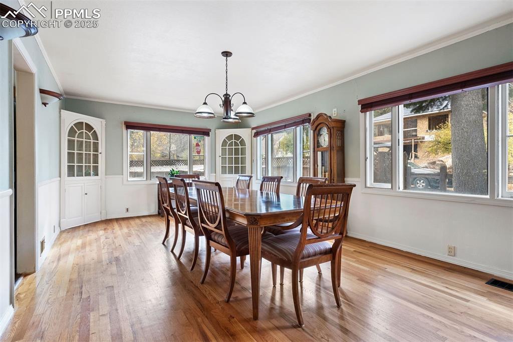 1515 West Cheyenne Road Colorado Springs, CO 80906 - Photo 6 of 50 a view of a dining room with furniture wooden floor and chandelier