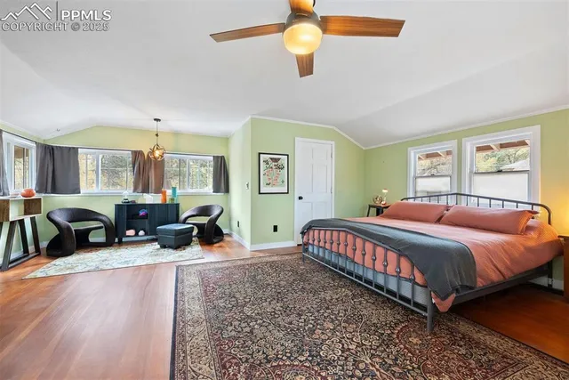 a bed room with a bed couch and a window