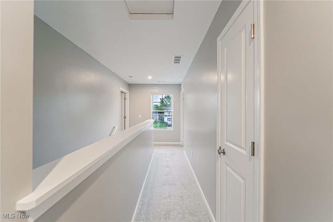 6105 Dunham Road Maple Heights, OH 44137 - Photo 10 of 38 Hallway featuring light colored carpet, baseboards, and an upstairs landing
