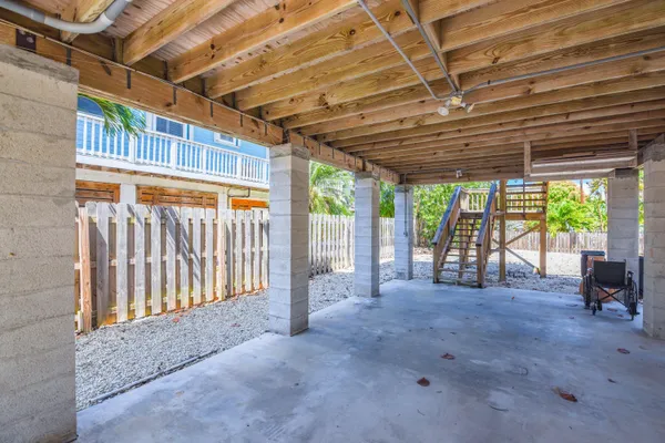 a view of porch with a table and chairs
