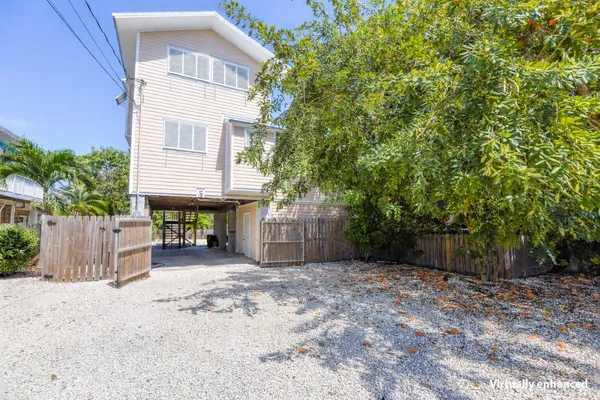 a view of a house with a yard and tree
