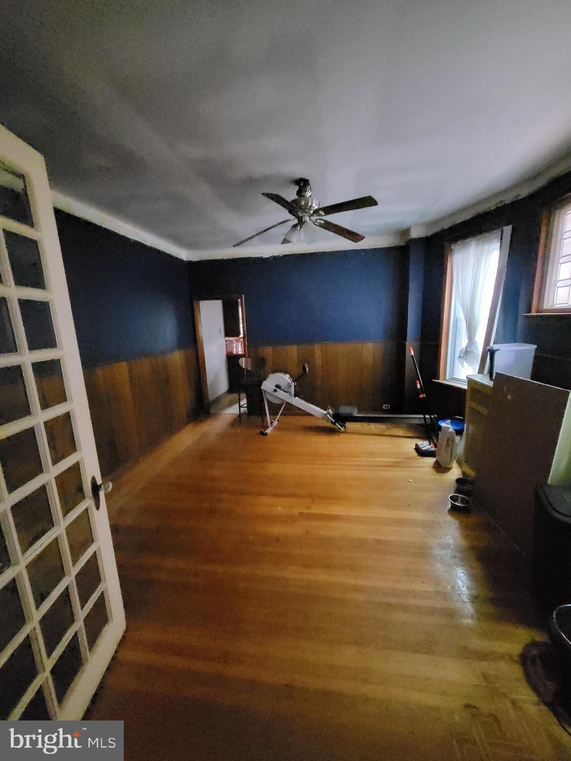 1117 South 61st Street Philadelphia, PA 19143 - Photo 2 of 7 a bedroom with a bed and wooden floor