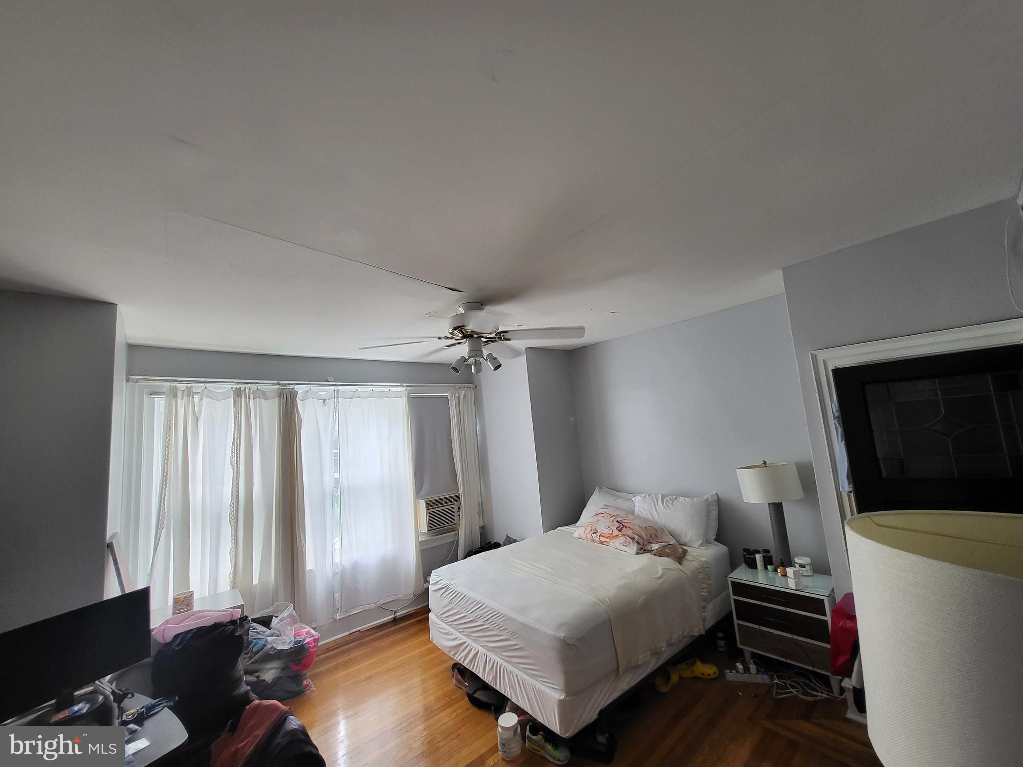 1117 South 61st Street Philadelphia, PA 19143 - Photo 3 of 7 a bedroom with a bed and a window