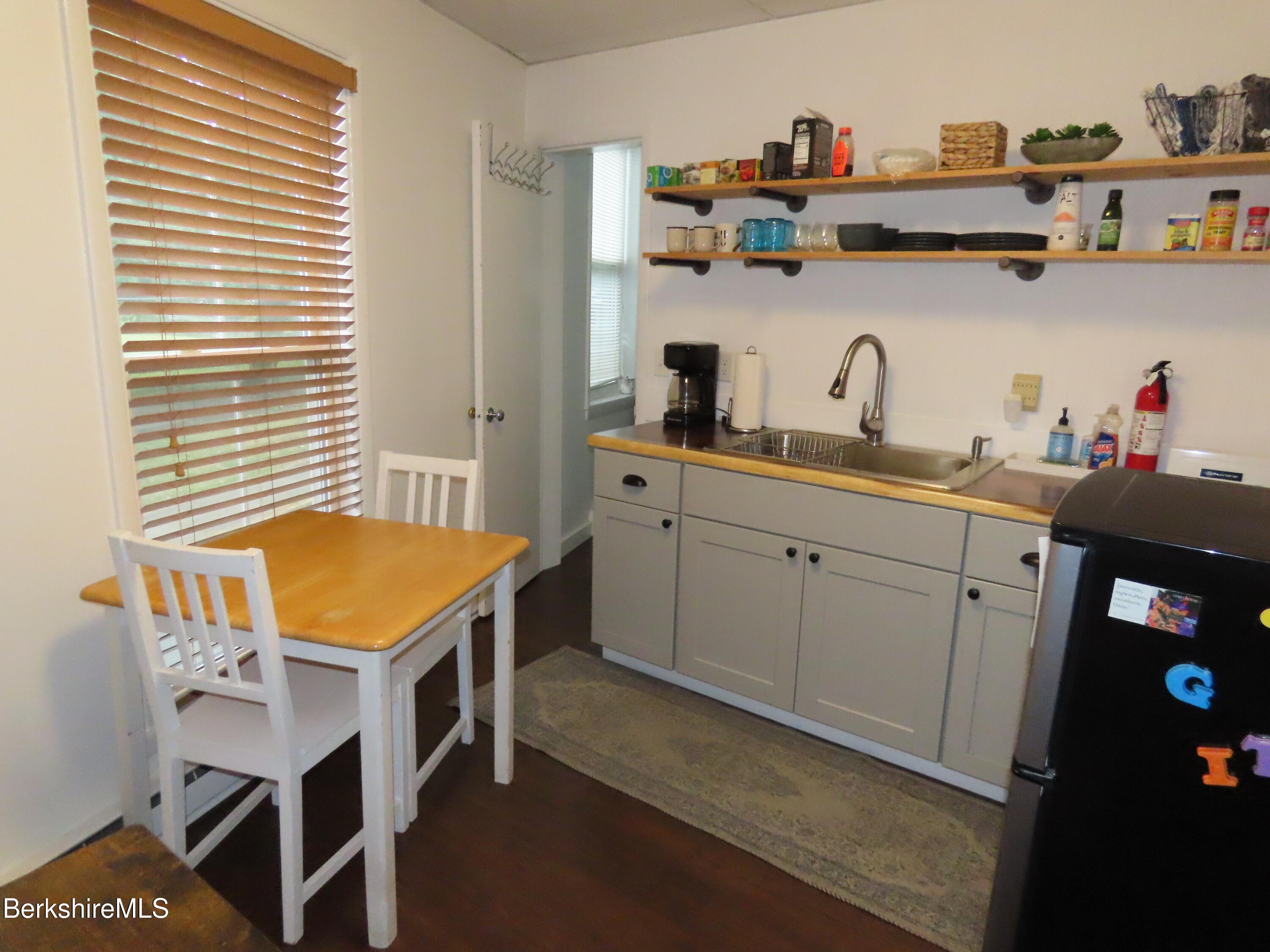 19 Church Street, Unit 12 North Adams, MA 01247 - Photo 5 of 16 a view of a kitchen with cabinets and wooden floor