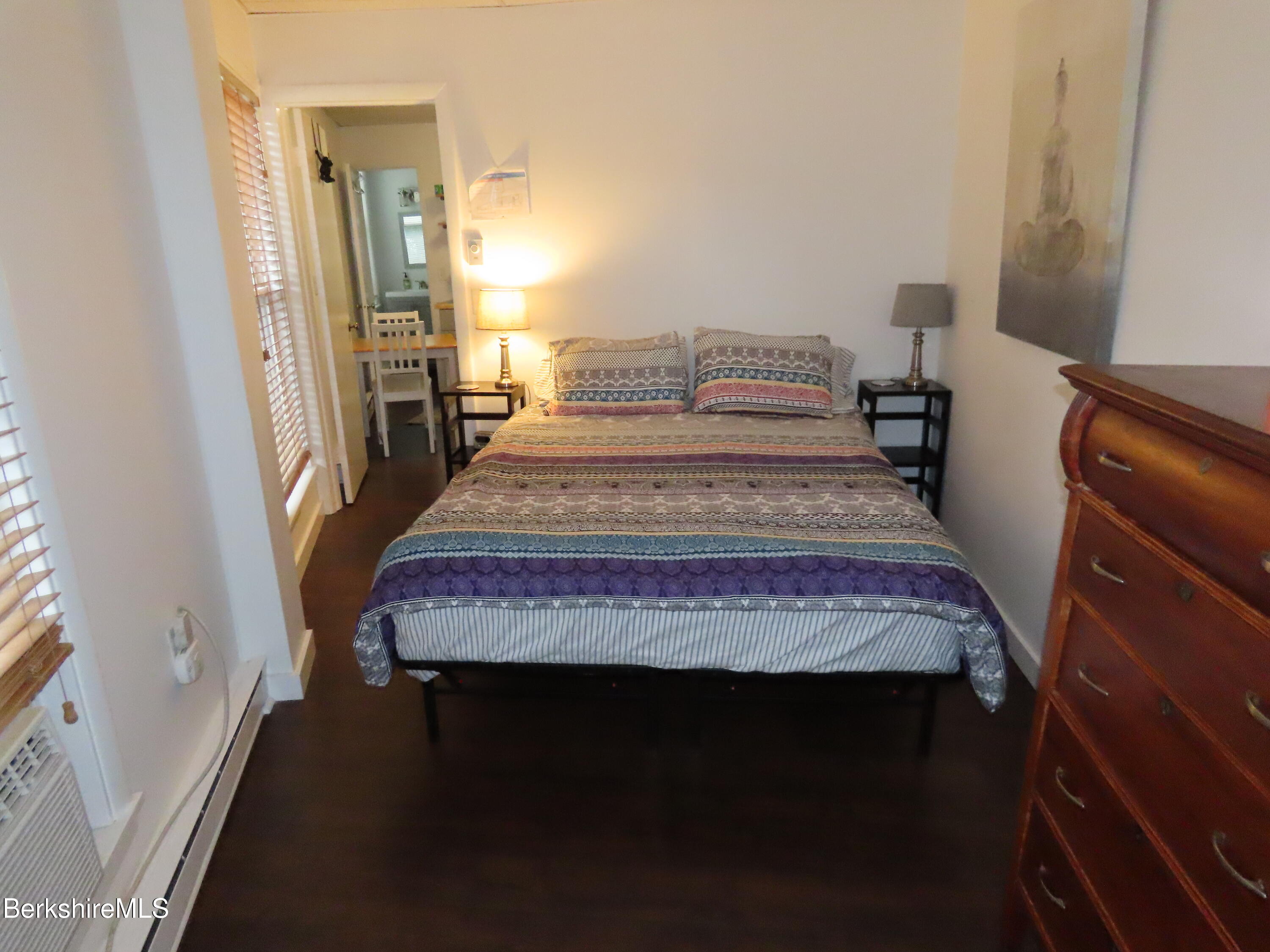 19 Church Street, Unit 12 North Adams, MA 01247 - Photo 10 of 16 a bedroom with a bed and wooden floor