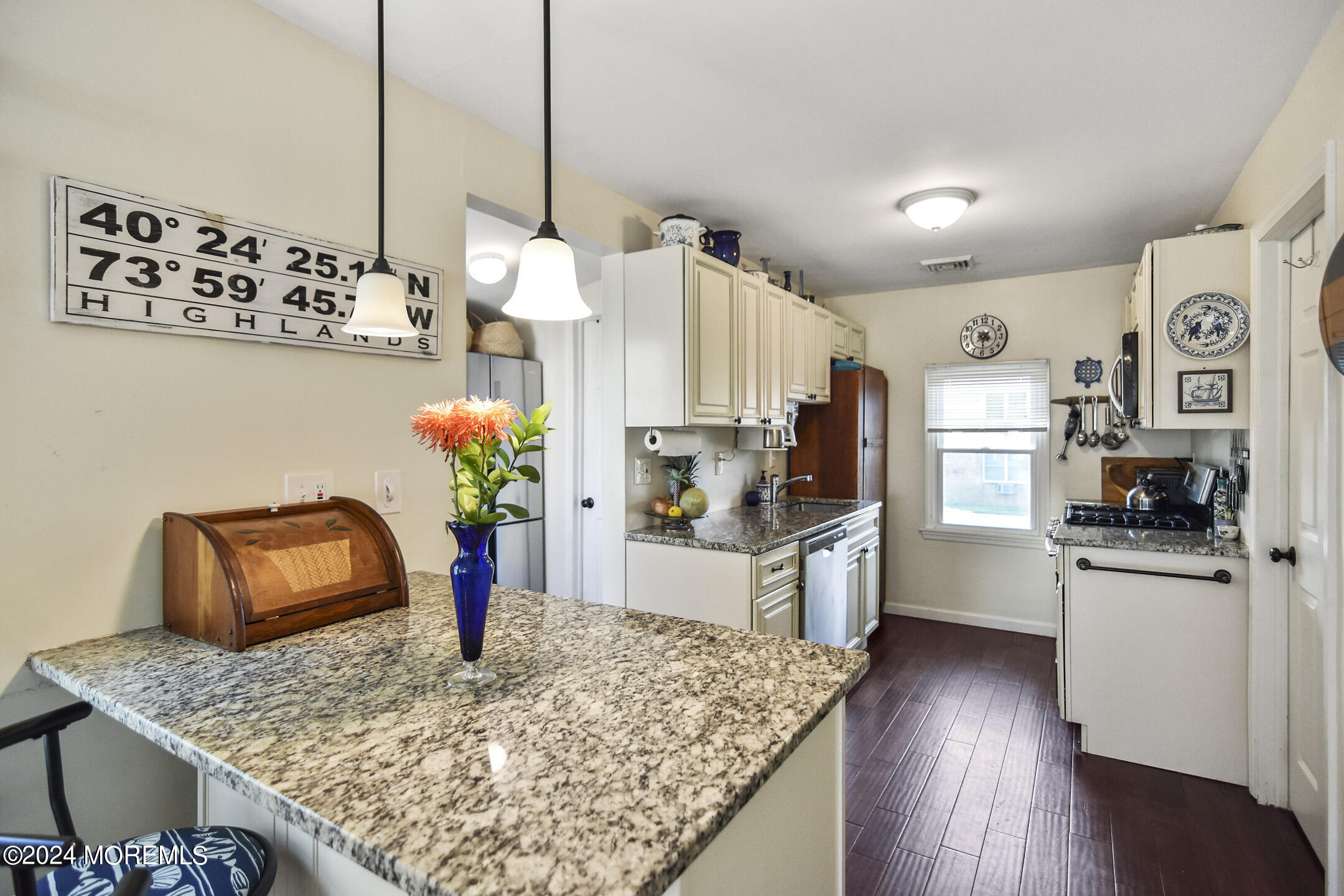 33 Gravelly Point Road Highlands, NJ 07732 - Photo 12 of 53 a kitchen with stainless steel appliances granite countertop a refrigerator a stove and a wooden floor