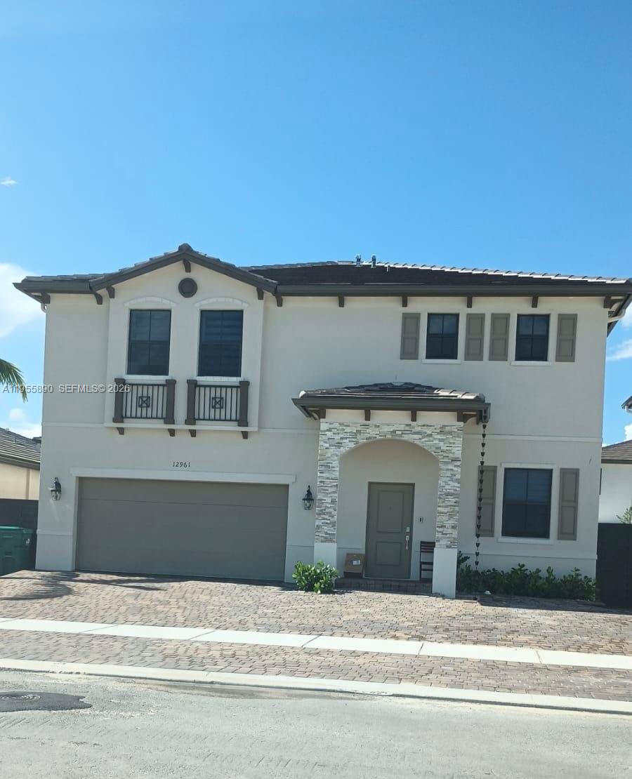 12961 Southwest 230th Street Miami, FL 33170 - Photo 1 of 39 a front view of a house with a garage