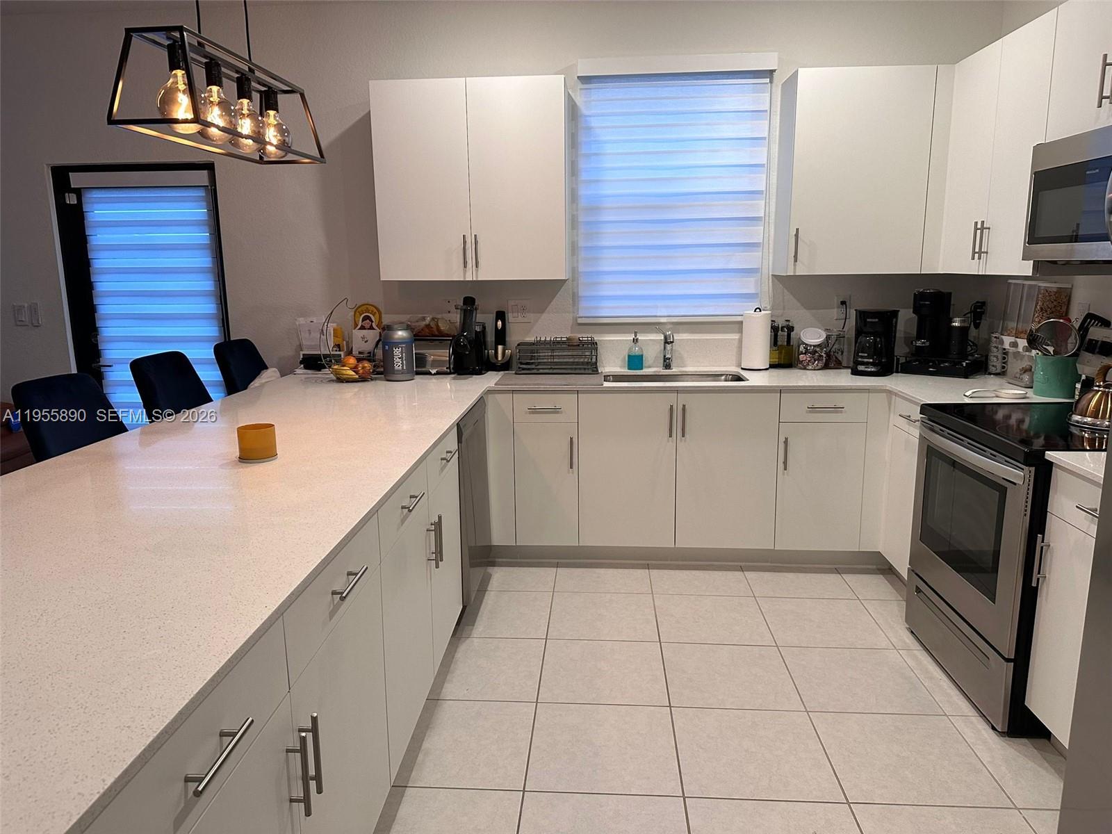 12961 Southwest 230th Street Miami, FL 33170 - Photo 12 of 39 a kitchen with a sink cabinets and appliances
