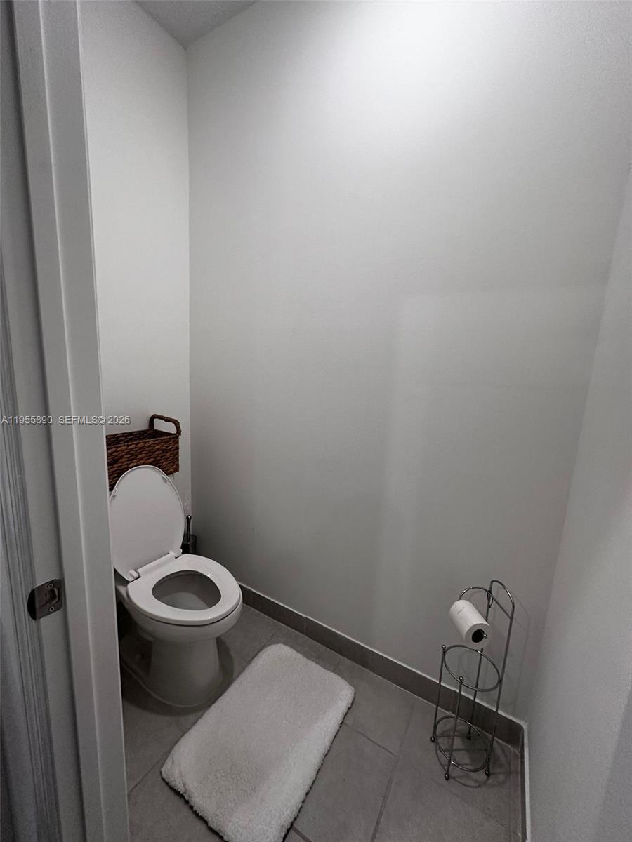 12961 Southwest 230th Street Miami, FL 33170 - Photo 15 of 39 a bathroom with a toilet and a rug