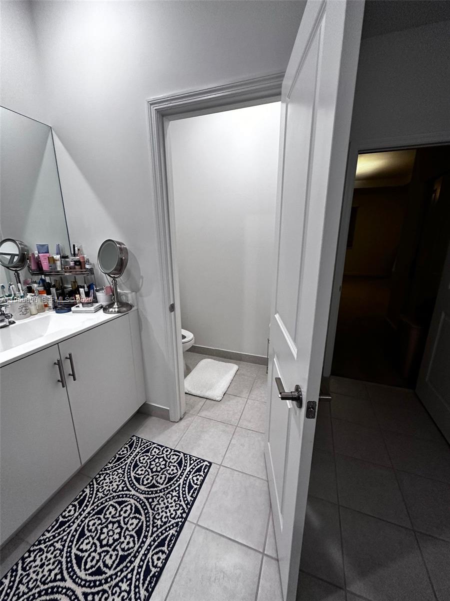 12961 Southwest 230th Street Miami, FL 33170 - Photo 16 of 39 a bathroom with a sink and a mirror