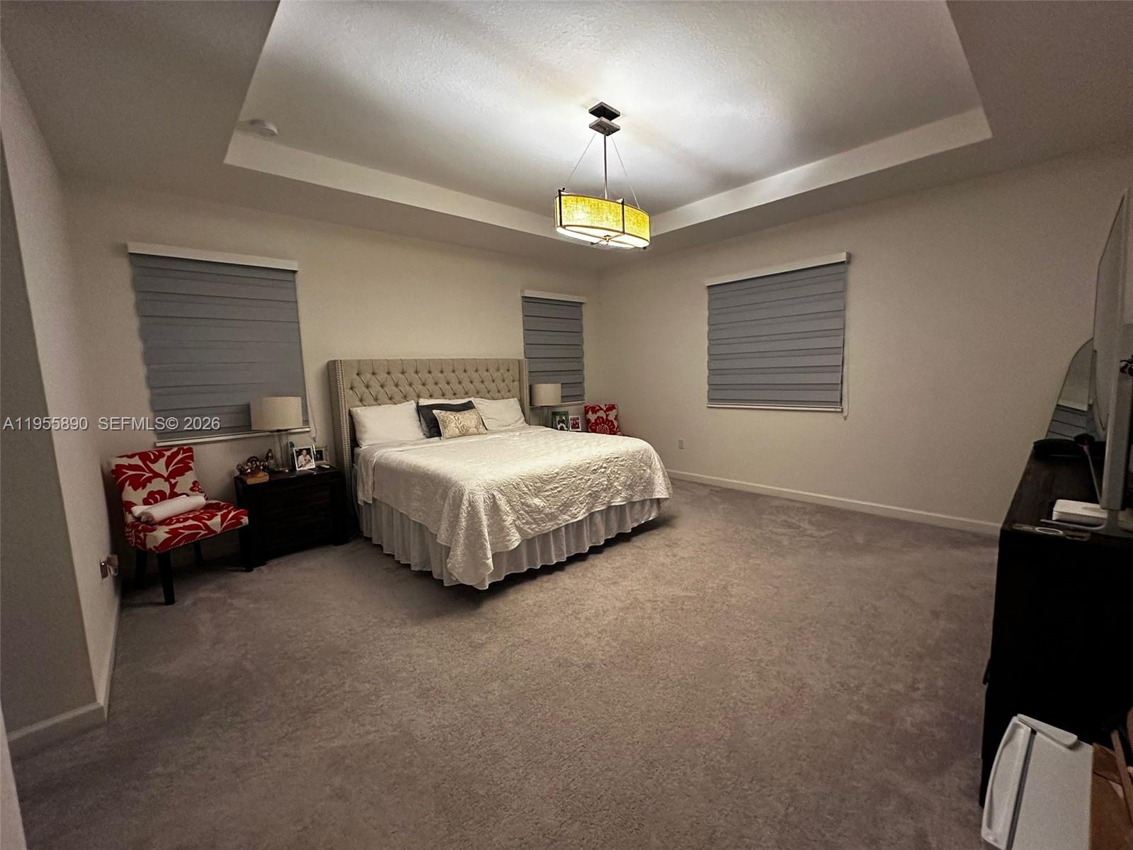 12961 Southwest 230th Street Miami, FL 33170 - Photo 18 of 39 a bedroom with a bed and a tv