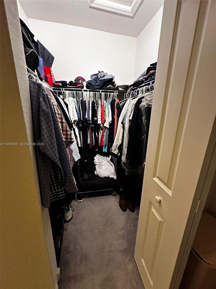 12961 Southwest 230th Street Miami, FL 33170 - Photo 19 of 39 a view of walk in closet with clothes and shoes