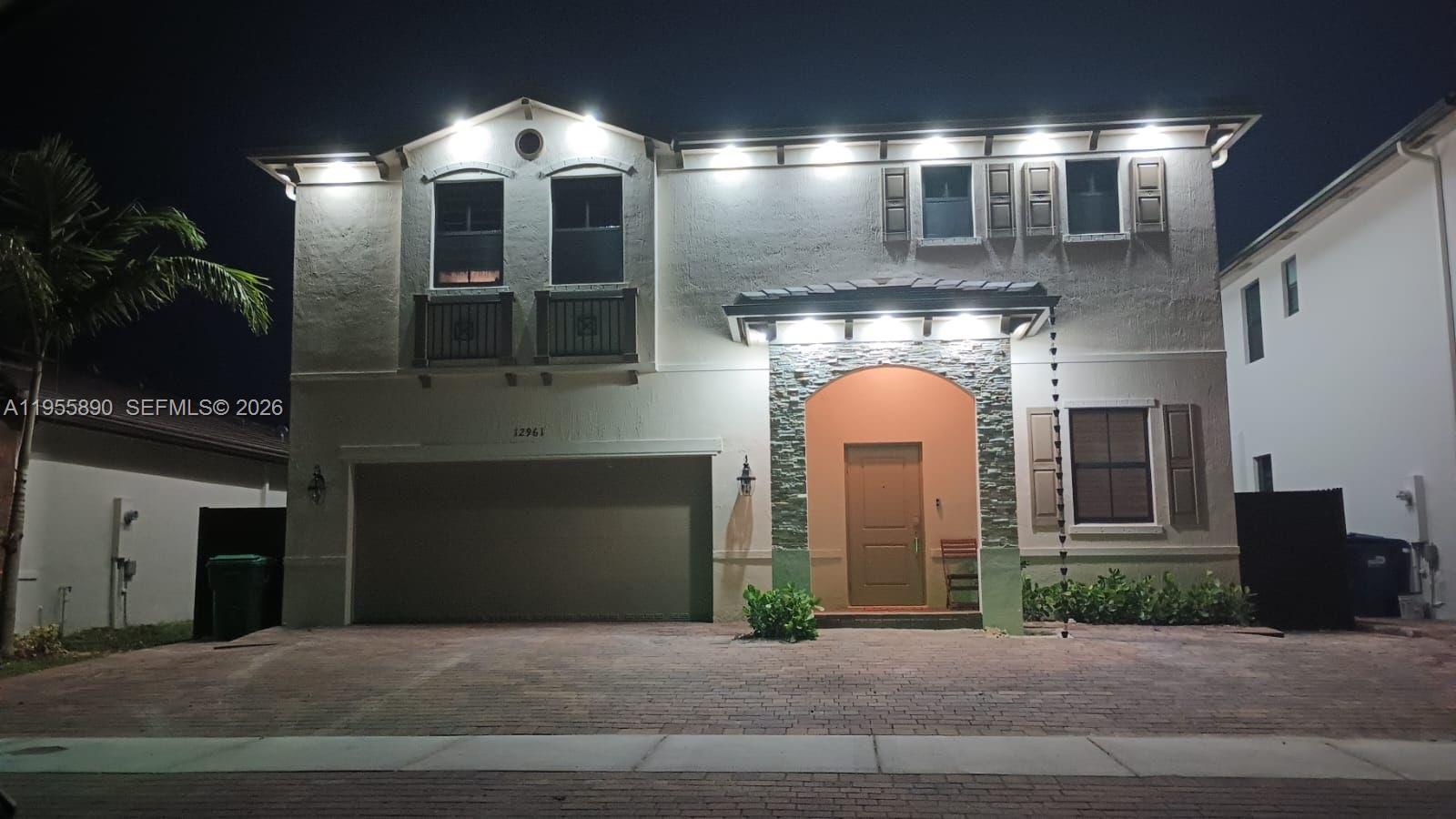 12961 Southwest 230th Street Miami, FL 33170 - Photo 2 of 39 a front view of a house with a yard