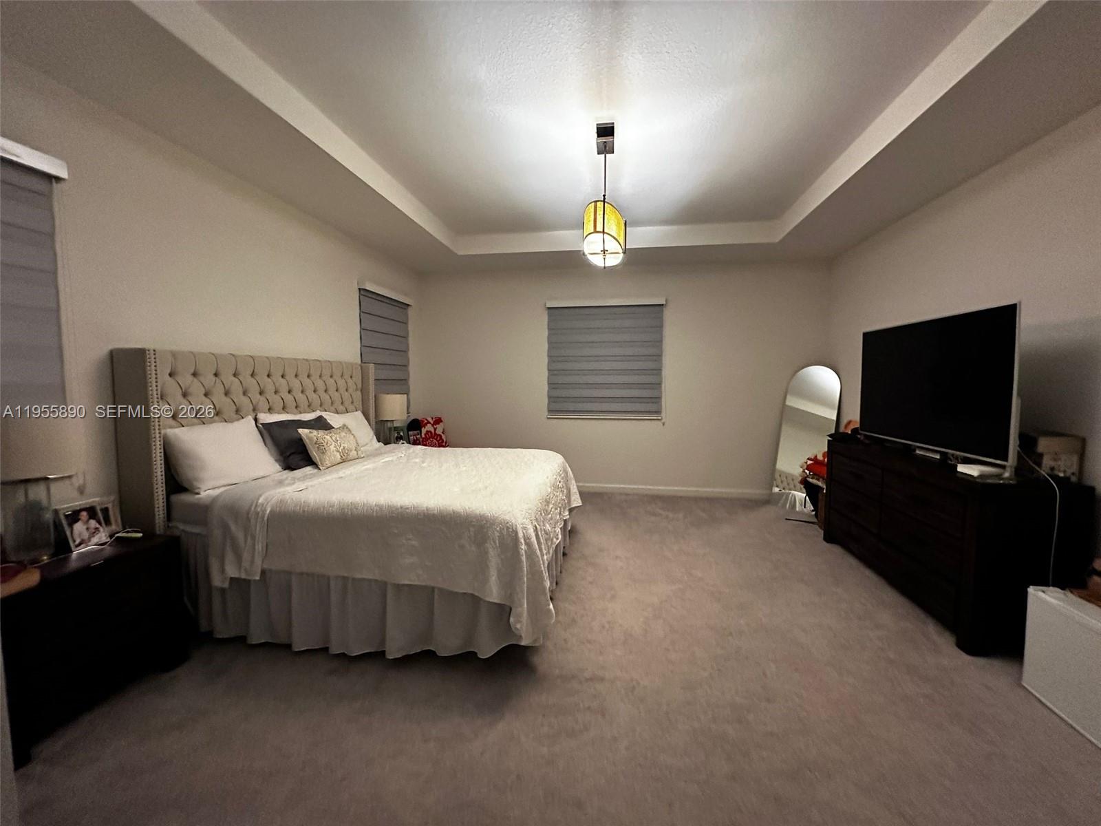 12961 Southwest 230th Street Miami, FL 33170 - Photo 21 of 39 a bedroom with a bed and a flat screen tv