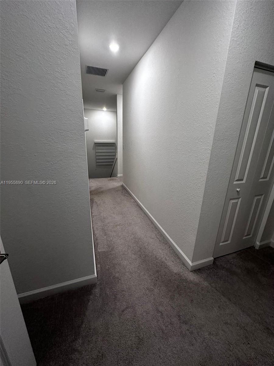 12961 Southwest 230th Street Miami, FL 33170 - Photo 22 of 39 an empty room with wooden floor and windows