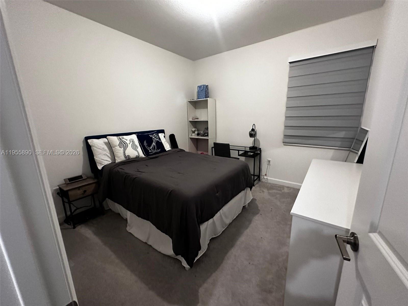 12961 Southwest 230th Street Miami, FL 33170 - Photo 24 of 39 a bedroom with a bed and window