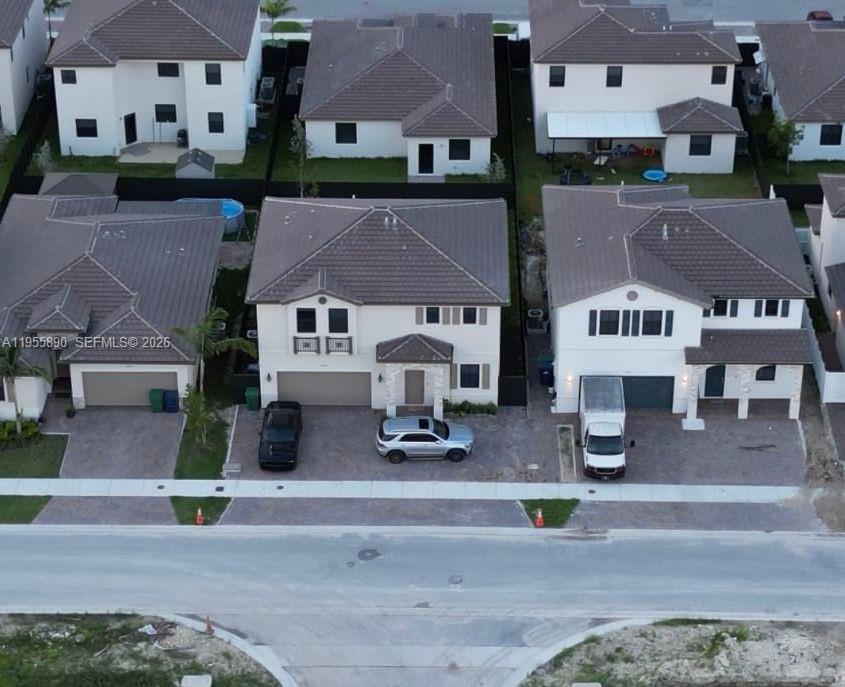 12961 Southwest 230th Street Miami, FL 33170 - Photo 3 of 39 an aerial view of multiple houses with street