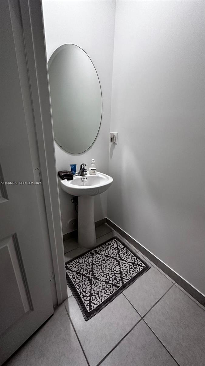 12961 Southwest 230th Street Miami, FL 33170 - Photo 34 of 39 a bathroom with a toilet a sink and mirror