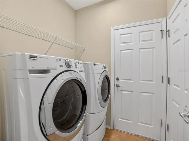 a living room with furniture and floor to ceiling windows