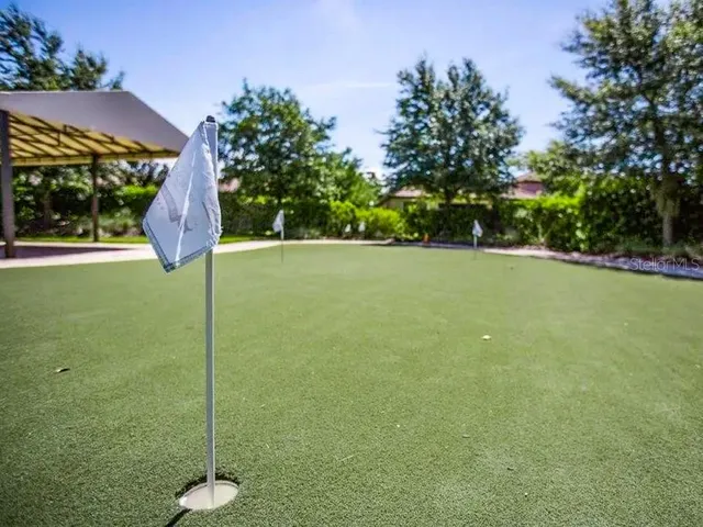 a swimming pool with outdoor seating and yard
