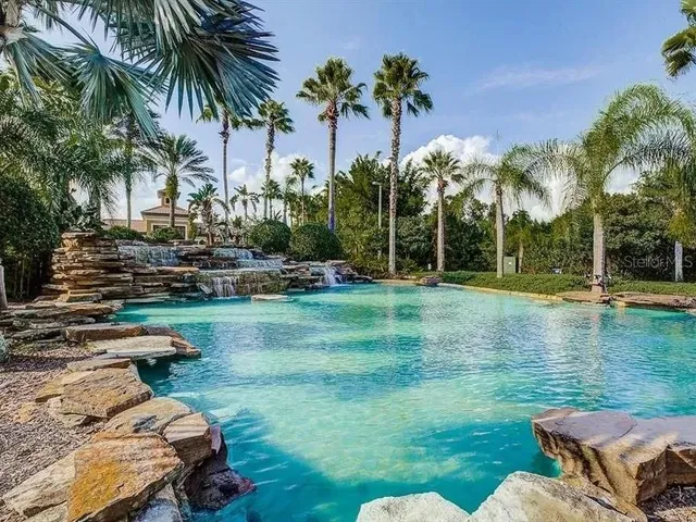 a view of a swimming pool with a yard