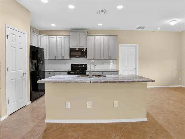 a kitchen with stainless steel appliances granite countertop a sink and cabinets