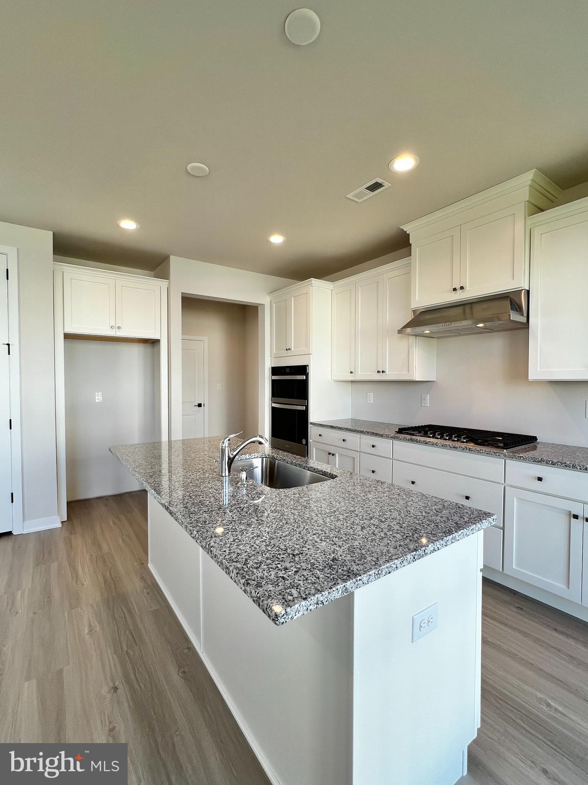 1018 East Lock Road Middletown, DE 19709 - Photo 11 of 51 a kitchen with stainless steel appliances granite countertop a stove and a sink