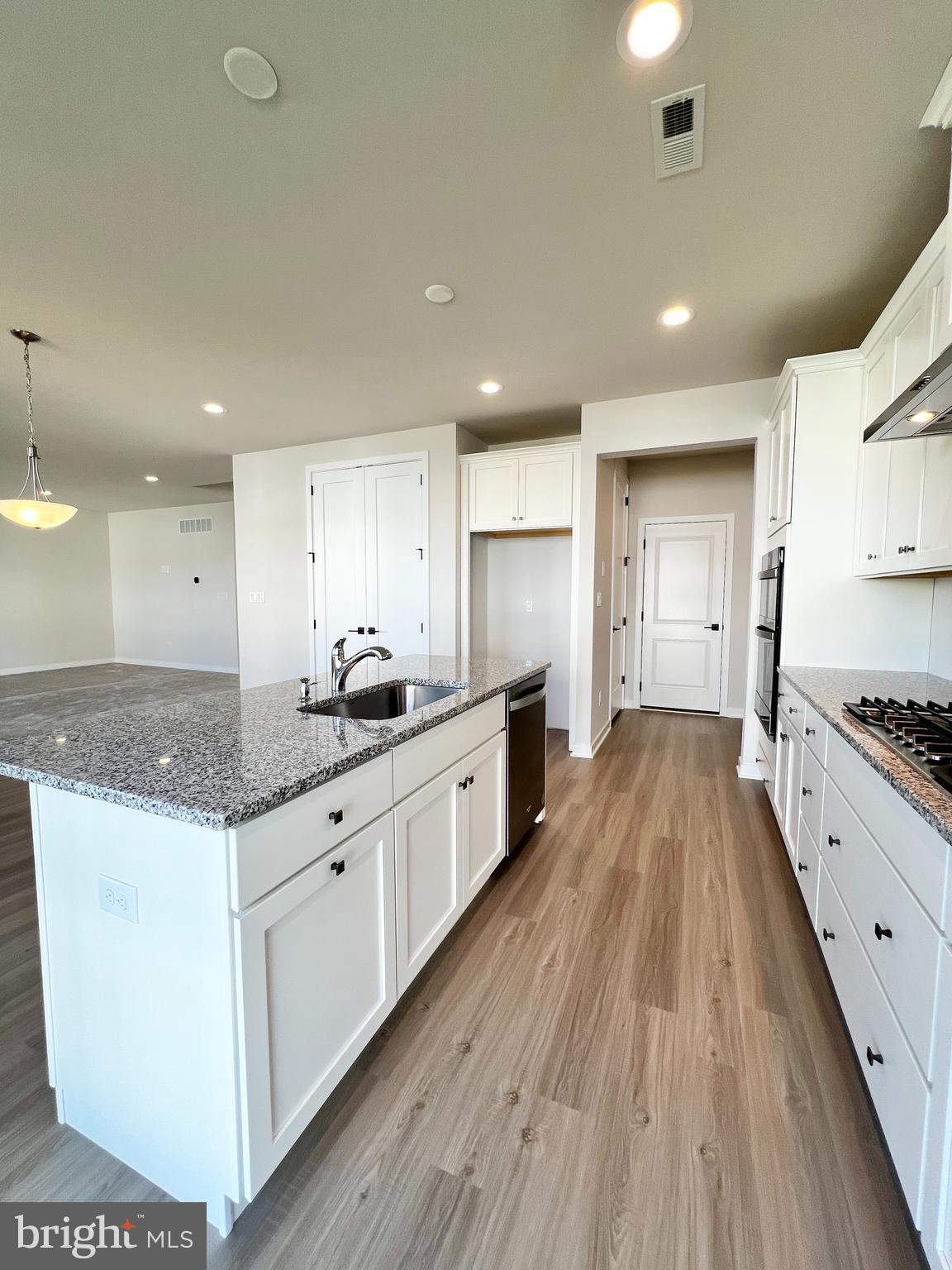 1018 East Lock Road Middletown, DE 19709 - Photo 12 of 51 a large kitchen with stainless steel appliances granite countertop a lot of counter space and wooden floors