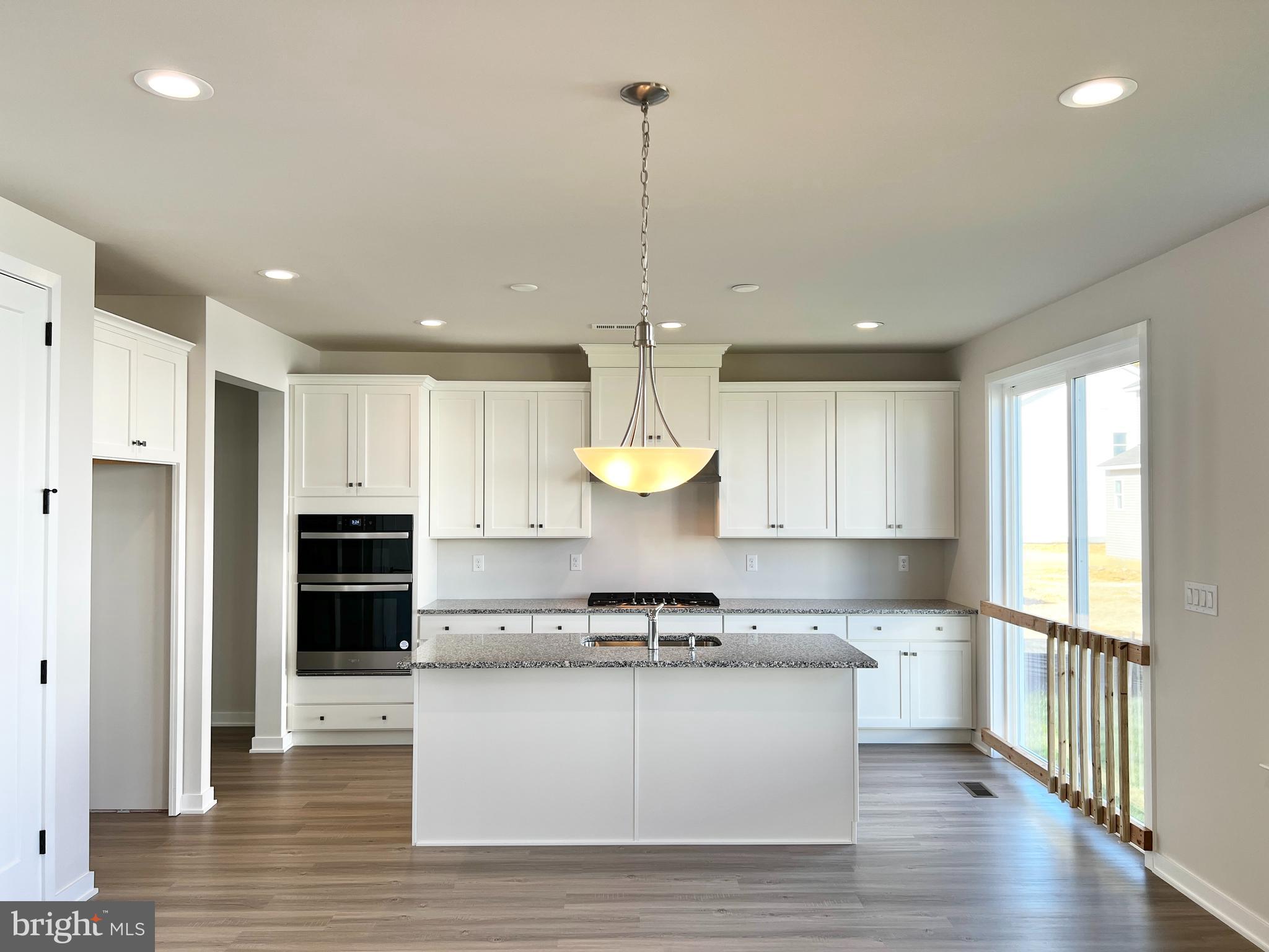 1018 East Lock Road Middletown, DE 19709 - Photo 3 of 51 a kitchen with stainless steel appliances granite countertop a stove a sink and white cabinets