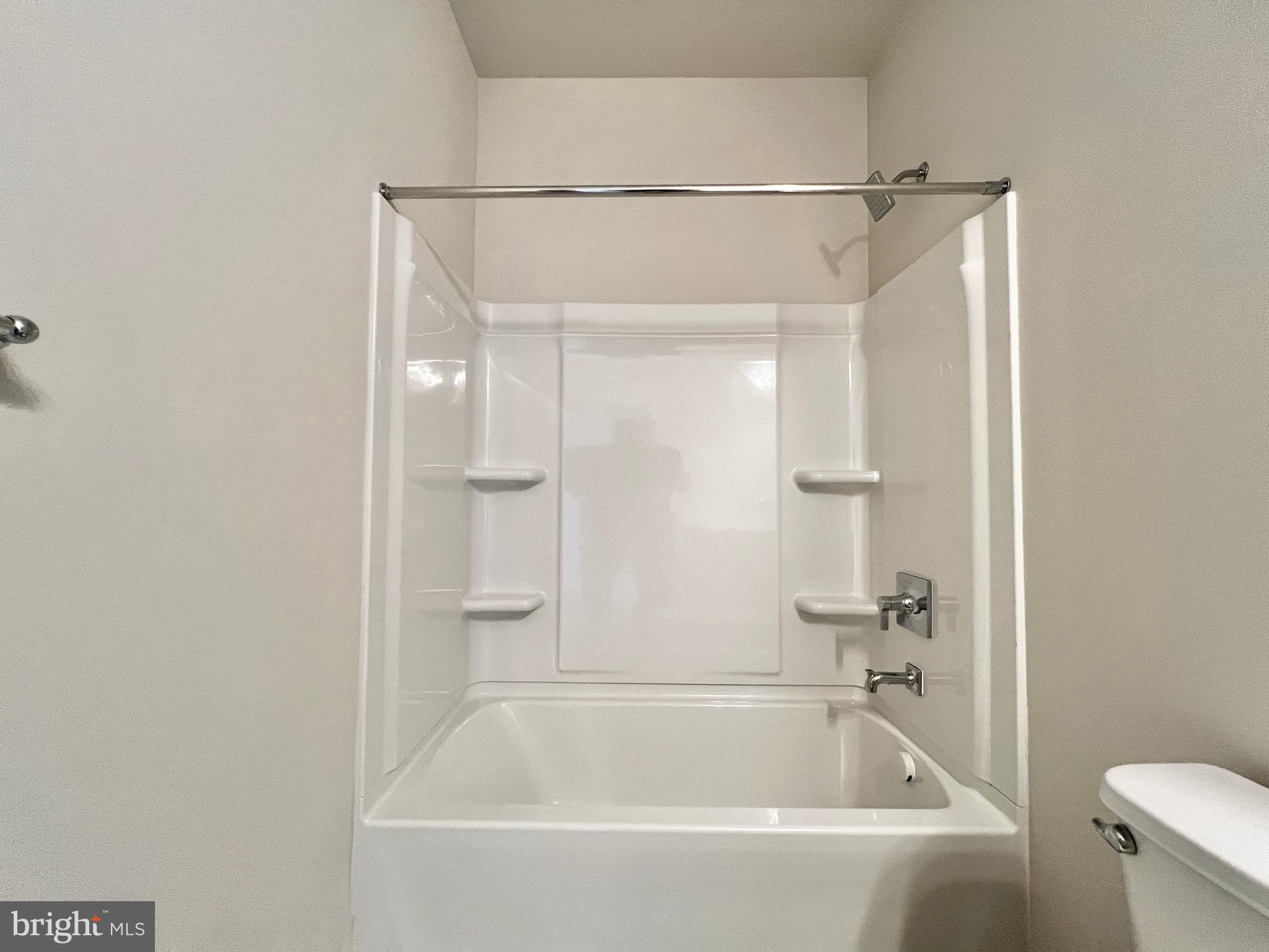 1018 East Lock Road Middletown, DE 19709 - Photo 40 of 51 a white bath tub sitting next to a white toilet and vanity