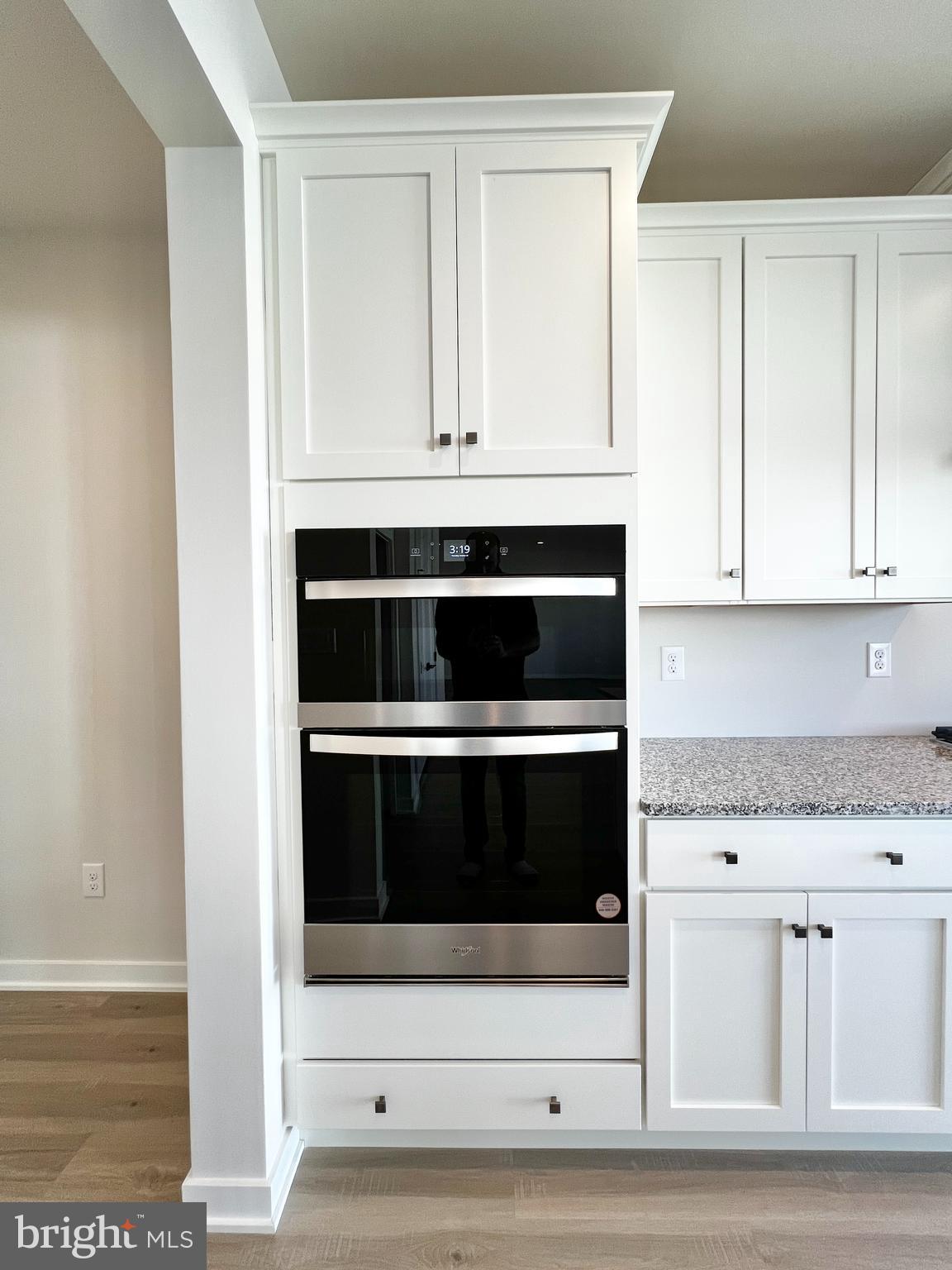 1018 East Lock Road Middletown, DE 19709 - Photo 5 of 51 a kitchen with granite countertop white cabinets and white appliances