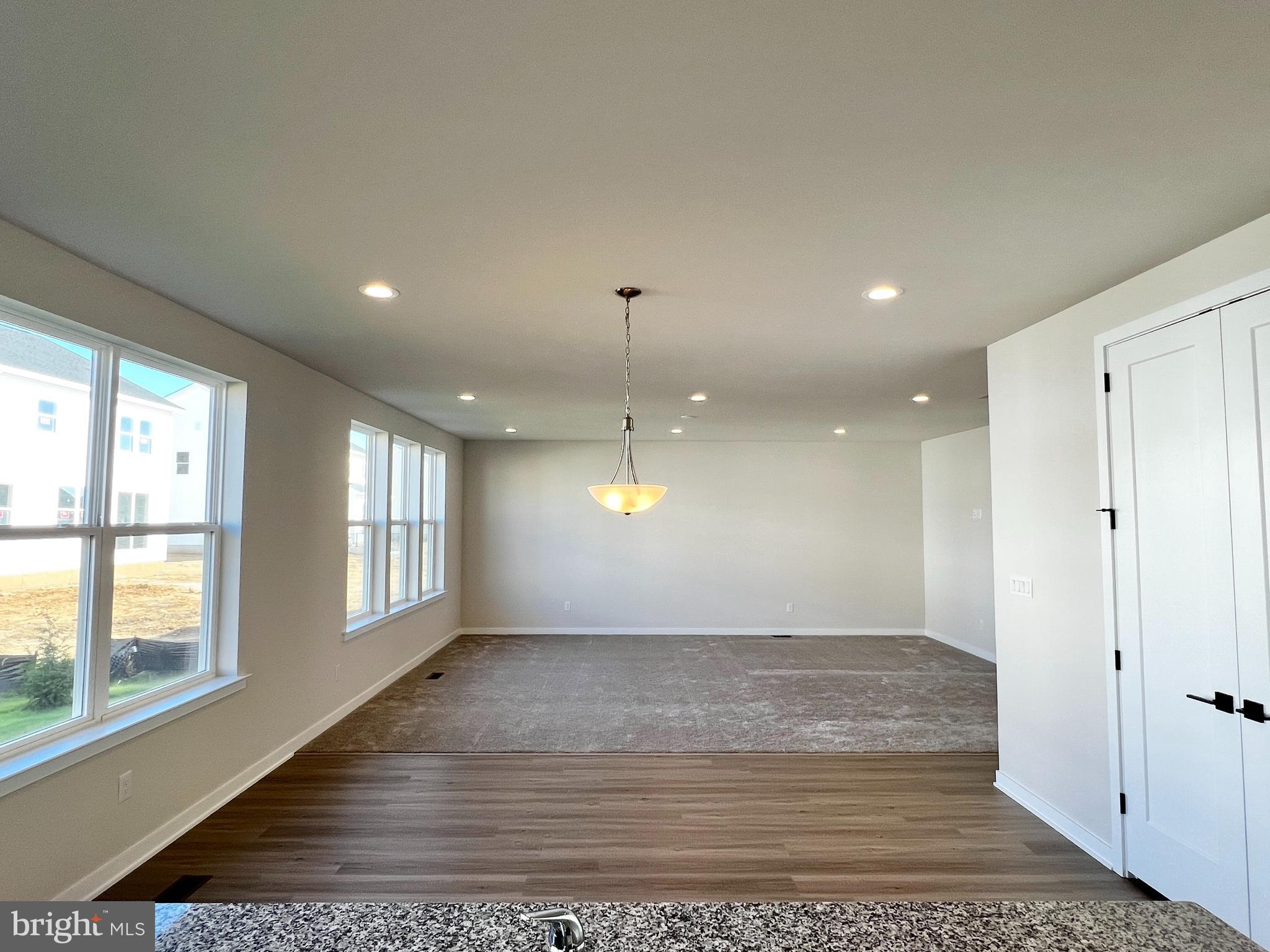 1018 East Lock Road Middletown, DE 19709 - Photo 8 of 51 an empty room with wooden floor and windows