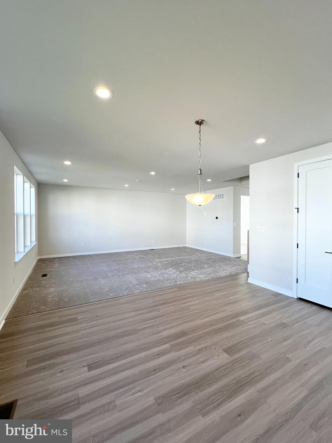 1018 East Lock Road Middletown, DE 19709 - Photo 9 of 51 an empty room with wooden floor and windows