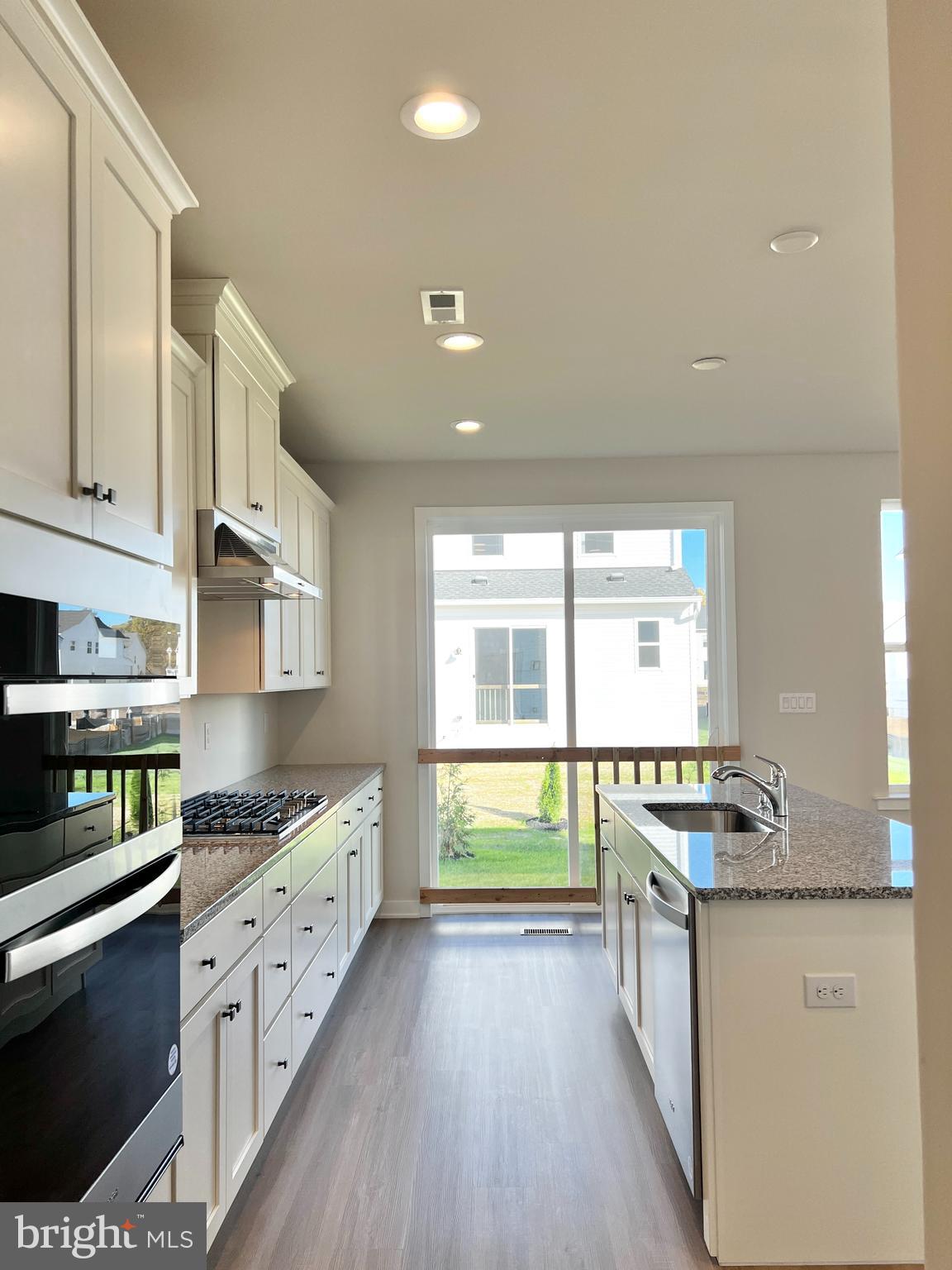 1018 East Lock Road Middletown, DE 19709 - Photo 10 of 51 a kitchen with stainless steel appliances granite countertop a stove a sink and a refrigerator
