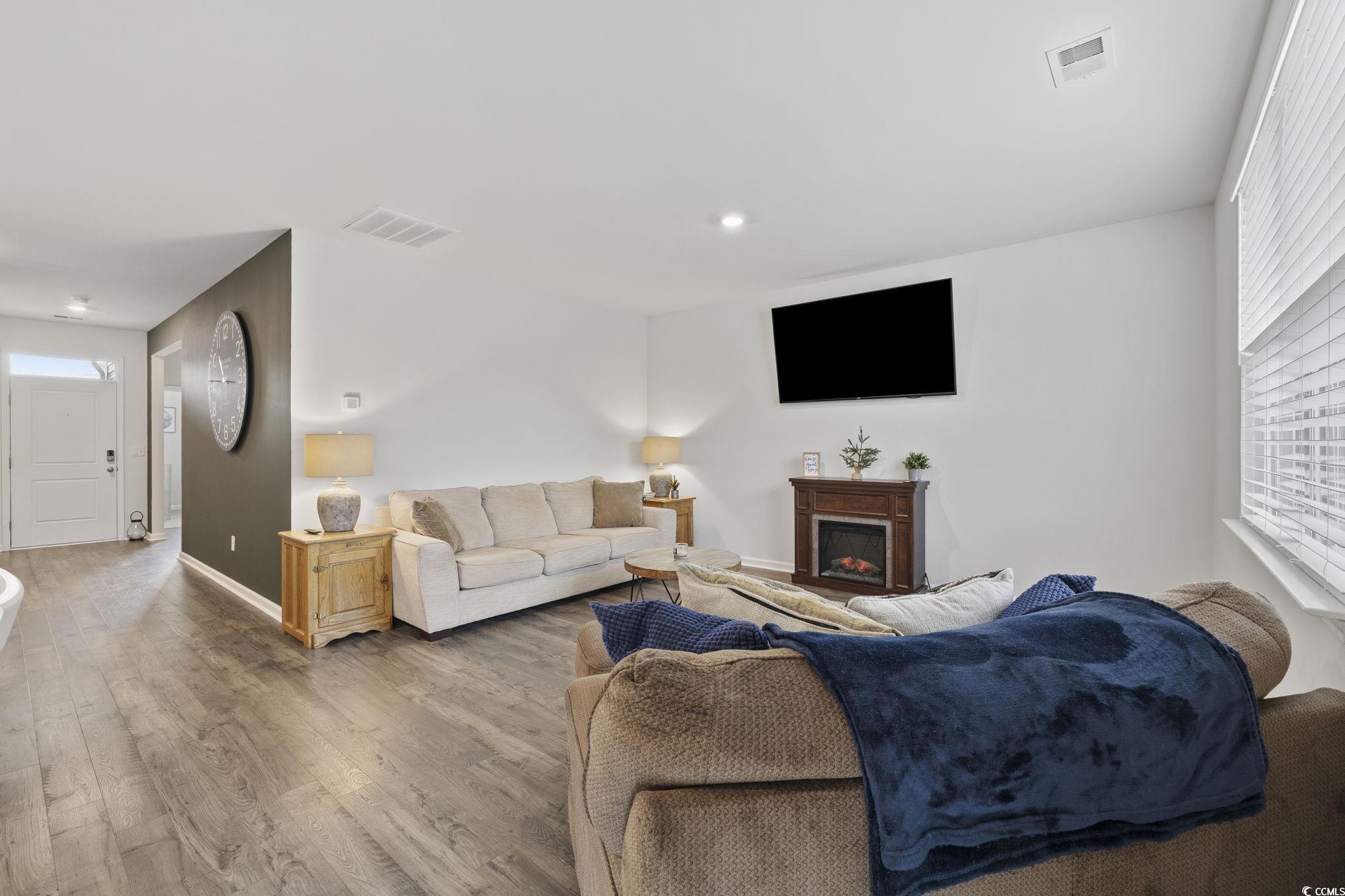 2816 Ophelia Way Myrtle Beach, SC 29577 - Photo 12 of 39 Living room with healthy amount of natural light, a fireplace, and wood finished floors
