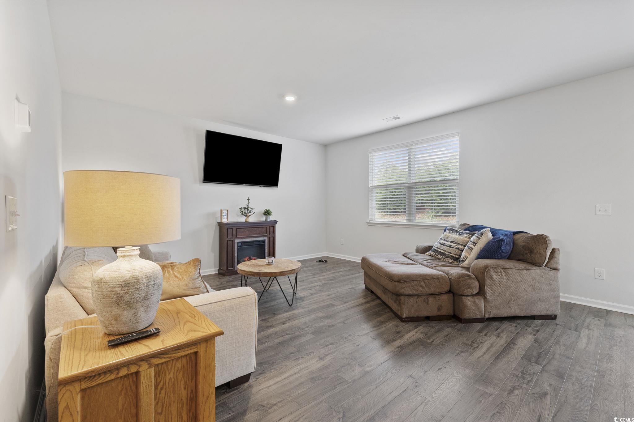 2816 Ophelia Way Myrtle Beach, SC 29577 - Photo 13 of 39 Living area featuring wood finished floors, recessed lighting, and a glass covered fireplace