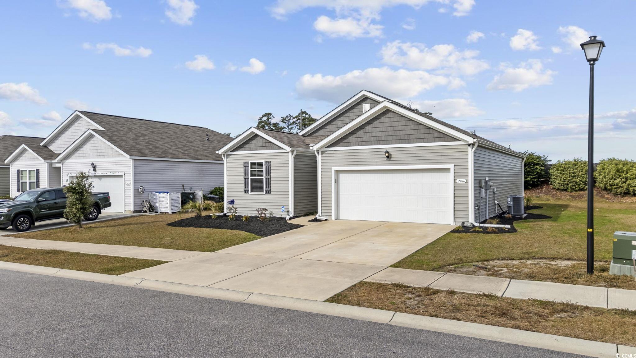 2816 Ophelia Way Myrtle Beach, SC 29577 - Photo 2 of 39 View of front of property with concrete driveway, a front lawn, and an attached garage