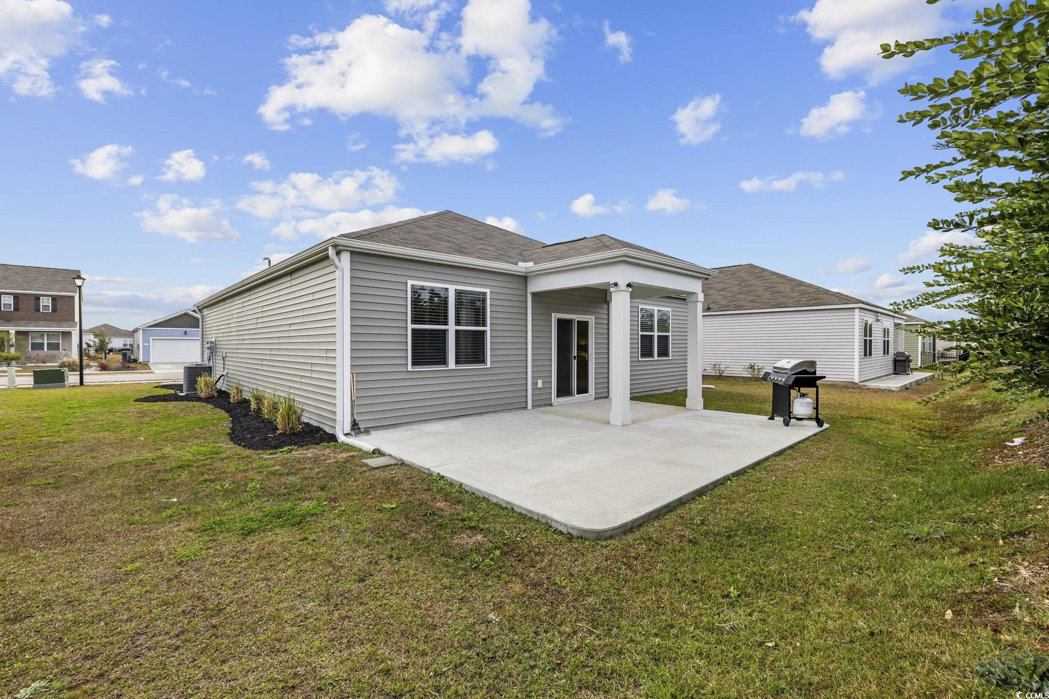 2816 Ophelia Way Myrtle Beach, SC 29577 - Photo 26 of 39 Rear view of house with a patio, a lawn, and a shingled roof