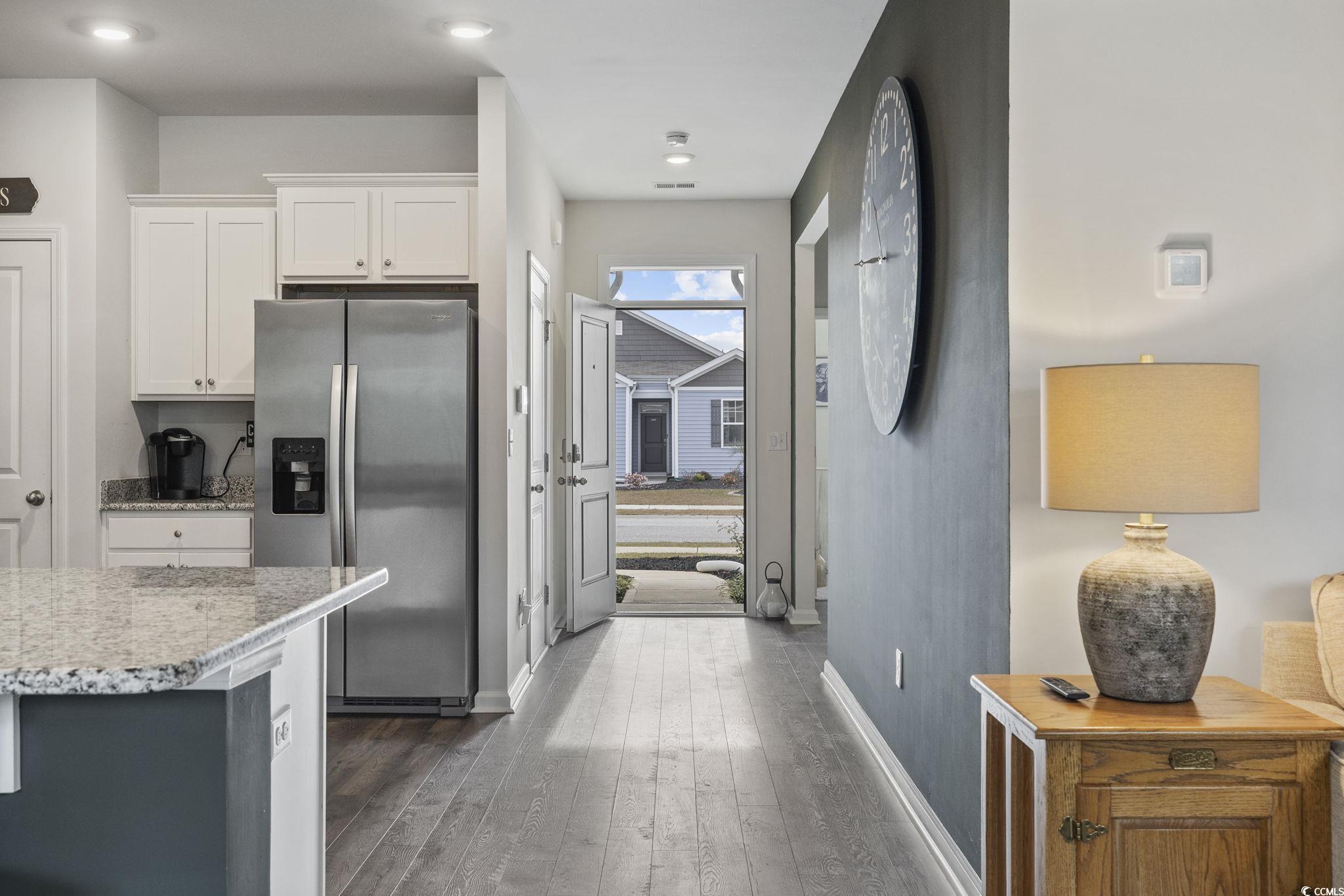 2816 Ophelia Way Myrtle Beach, SC 29577 - Photo 3 of 39 Kitchen with stainless steel fridge, white cabinetry, light stone counters, dark wood finished floors, and recessed lighting