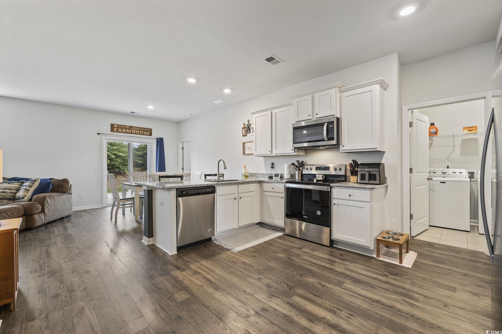 2816 Ophelia Way Myrtle Beach, SC 29577 - Photo 39 of 39 Kitchen with a peninsula, white cabinetry, appliances with stainless steel finishes, open floor plan, and recessed lighting