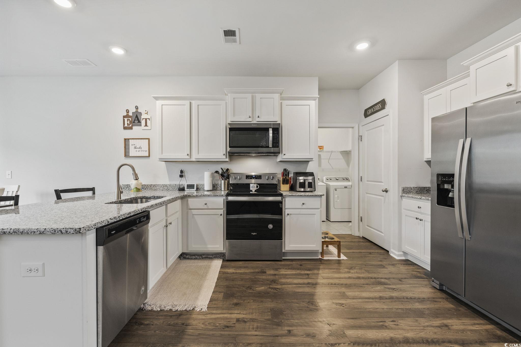 2816 Ophelia Way Myrtle Beach, SC 29577 - Photo 6 of 39 Kitchen with appliances with stainless steel finishes, a peninsula, white cabinetry, and recessed lighting