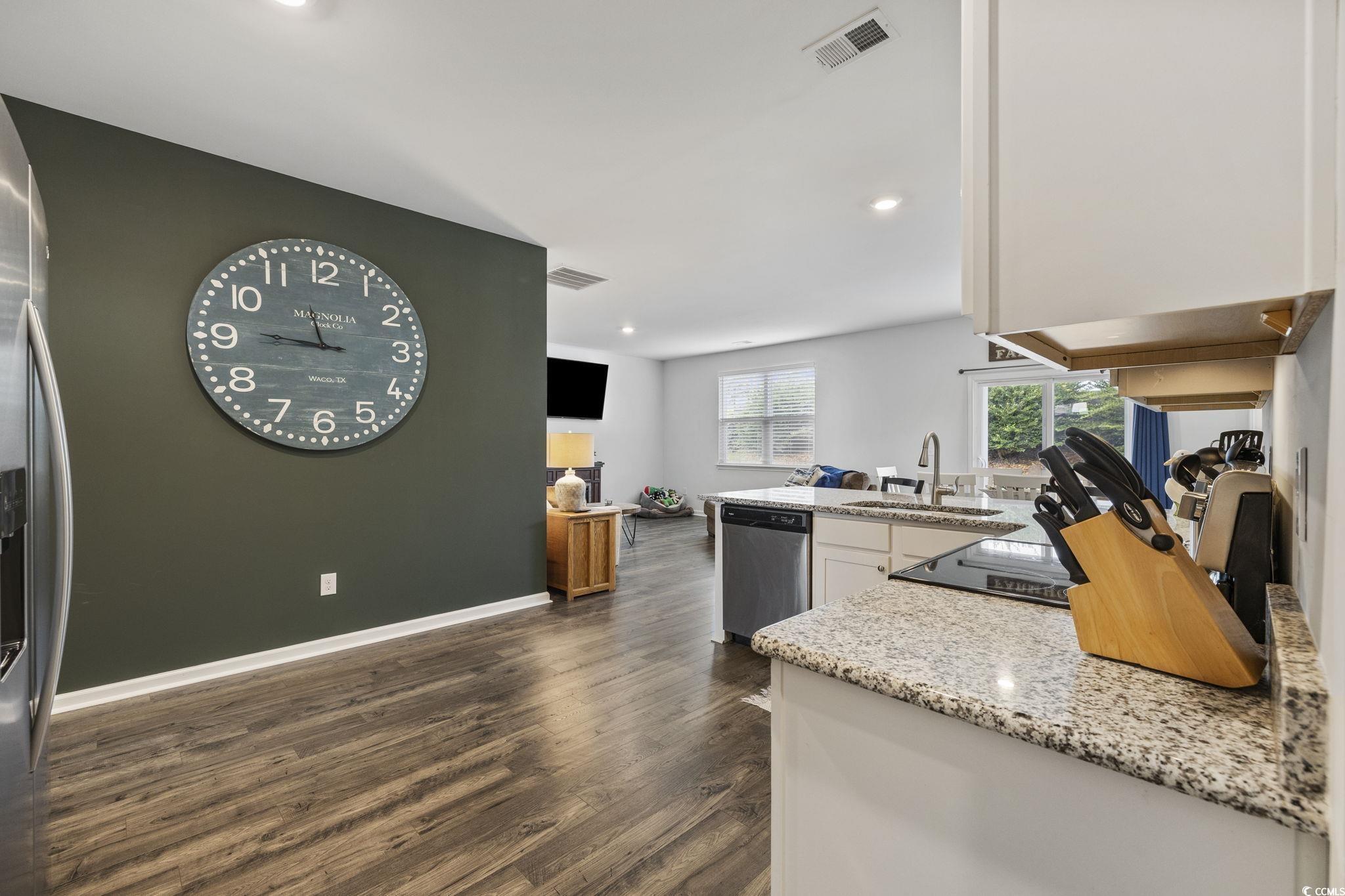2816 Ophelia Way Myrtle Beach, SC 29577 - Photo 7 of 39 Kitchen with light stone counters, a peninsula, dark wood-style floors, appliances with stainless steel finishes, and recessed lighting