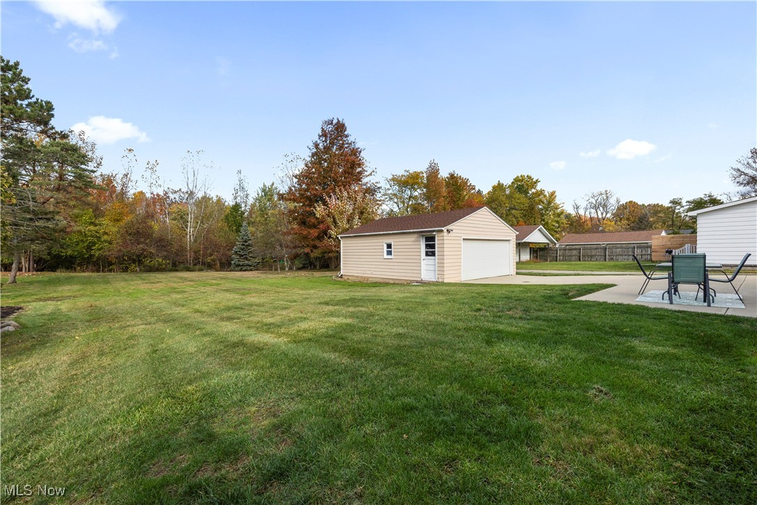 20114 Drake Road Strongsville, OH 44149 - Photo 34 of 35 View of yard with an outbuilding, a detached garage, and a patio
