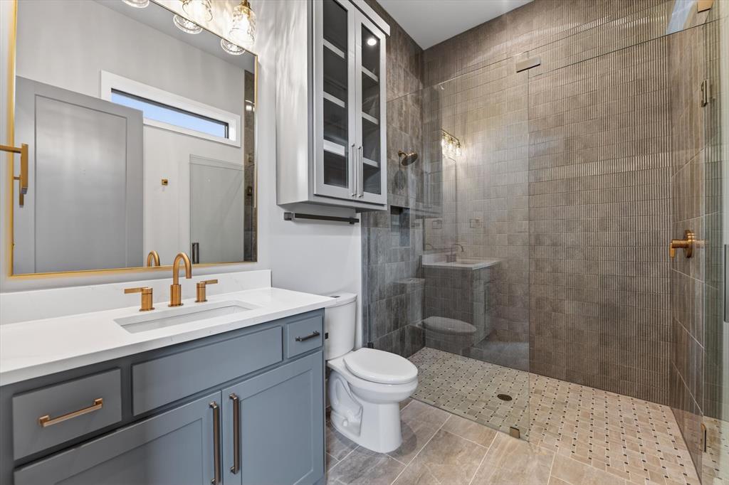 11028 Edgemere Road Dallas, TX 75230 - Photo 24 of 40 Walk-in shower with full glass enclosure and tiled walls