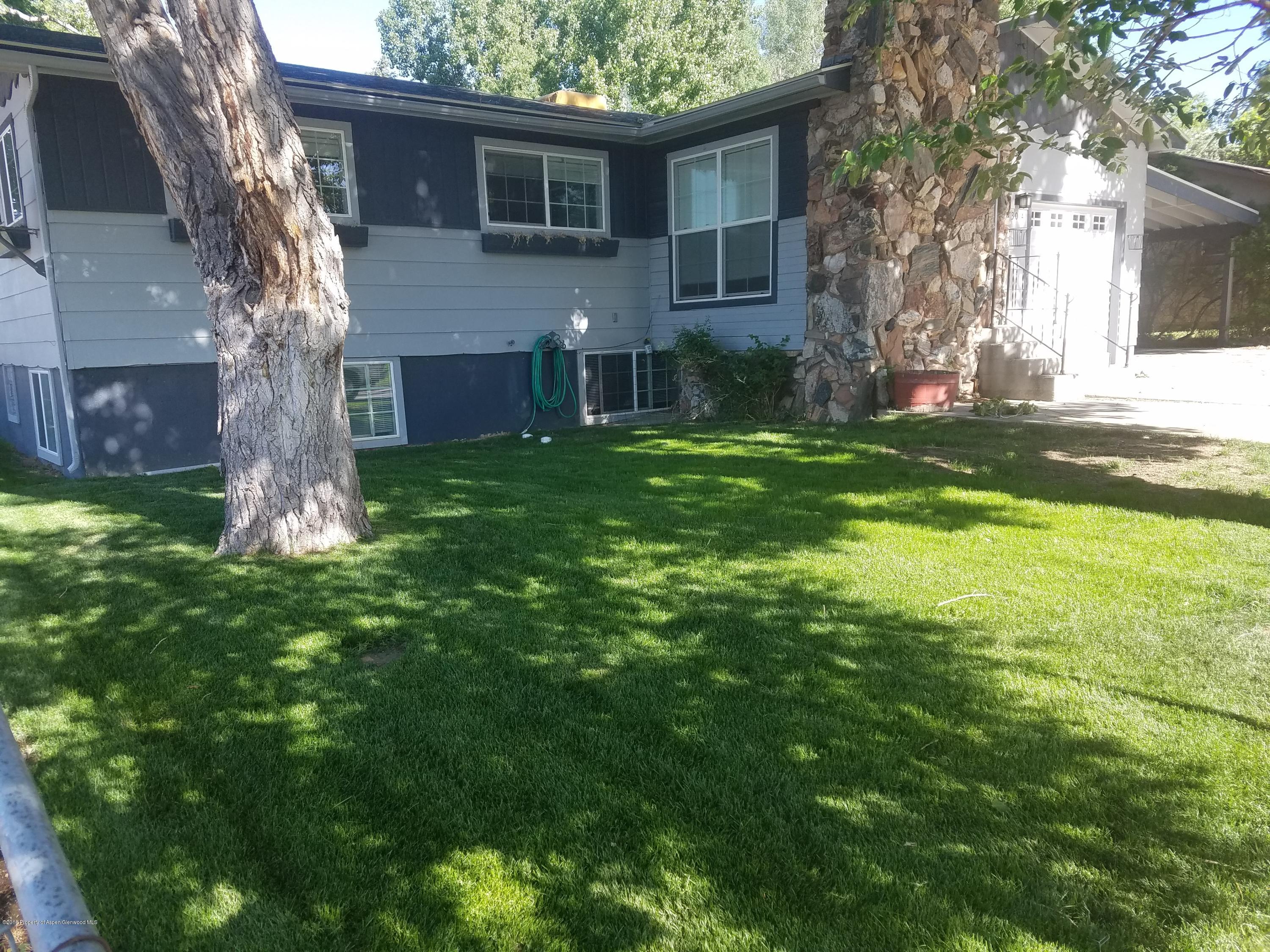 730 Green Street Craig, CO 81625 - Photo 1 of 34 a brick house with a tree in front of a house