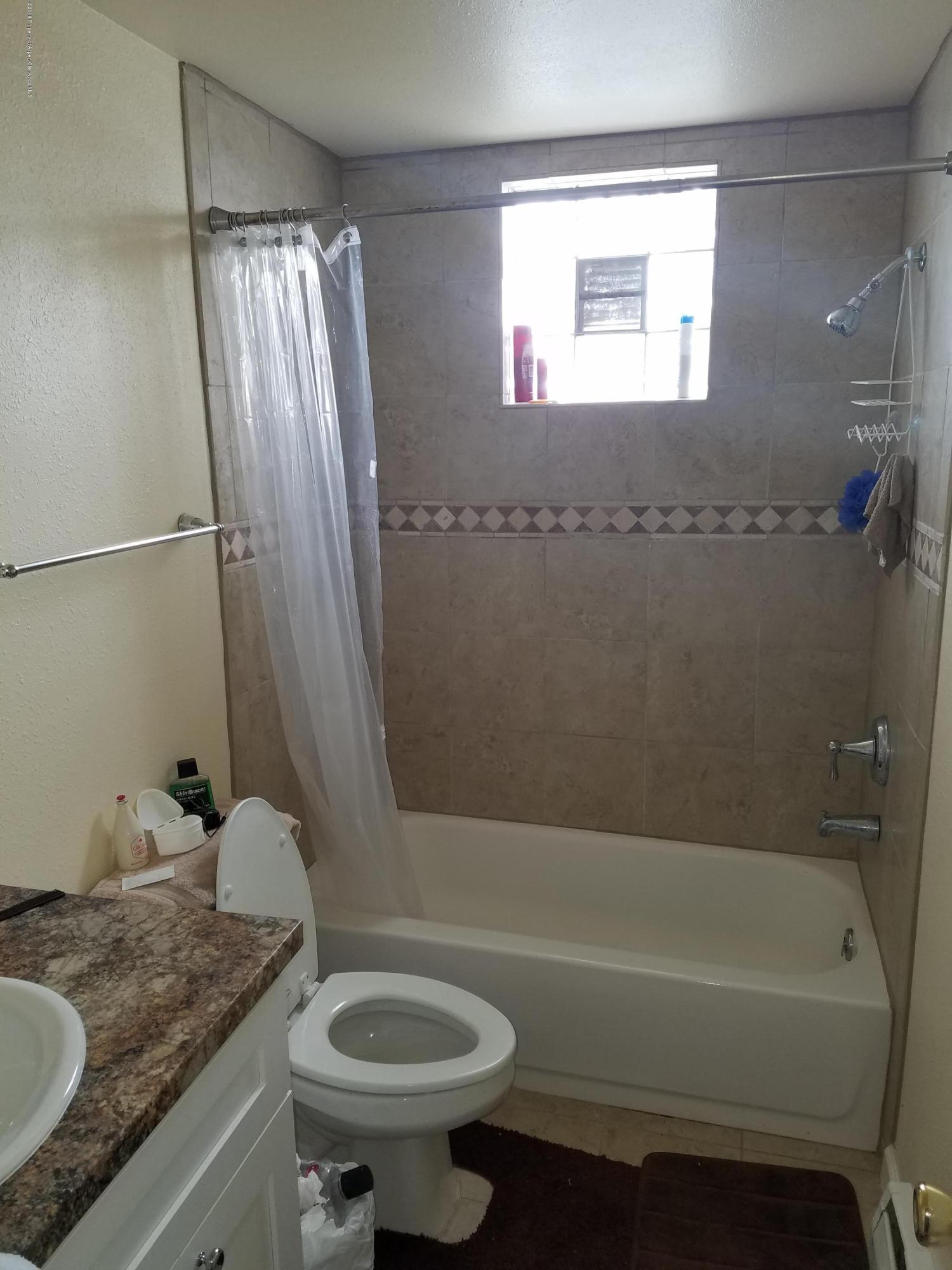 730 Green Street Craig, CO 81625 - Photo 14 of 34 a bathroom with a granite countertop sink toilet and shower