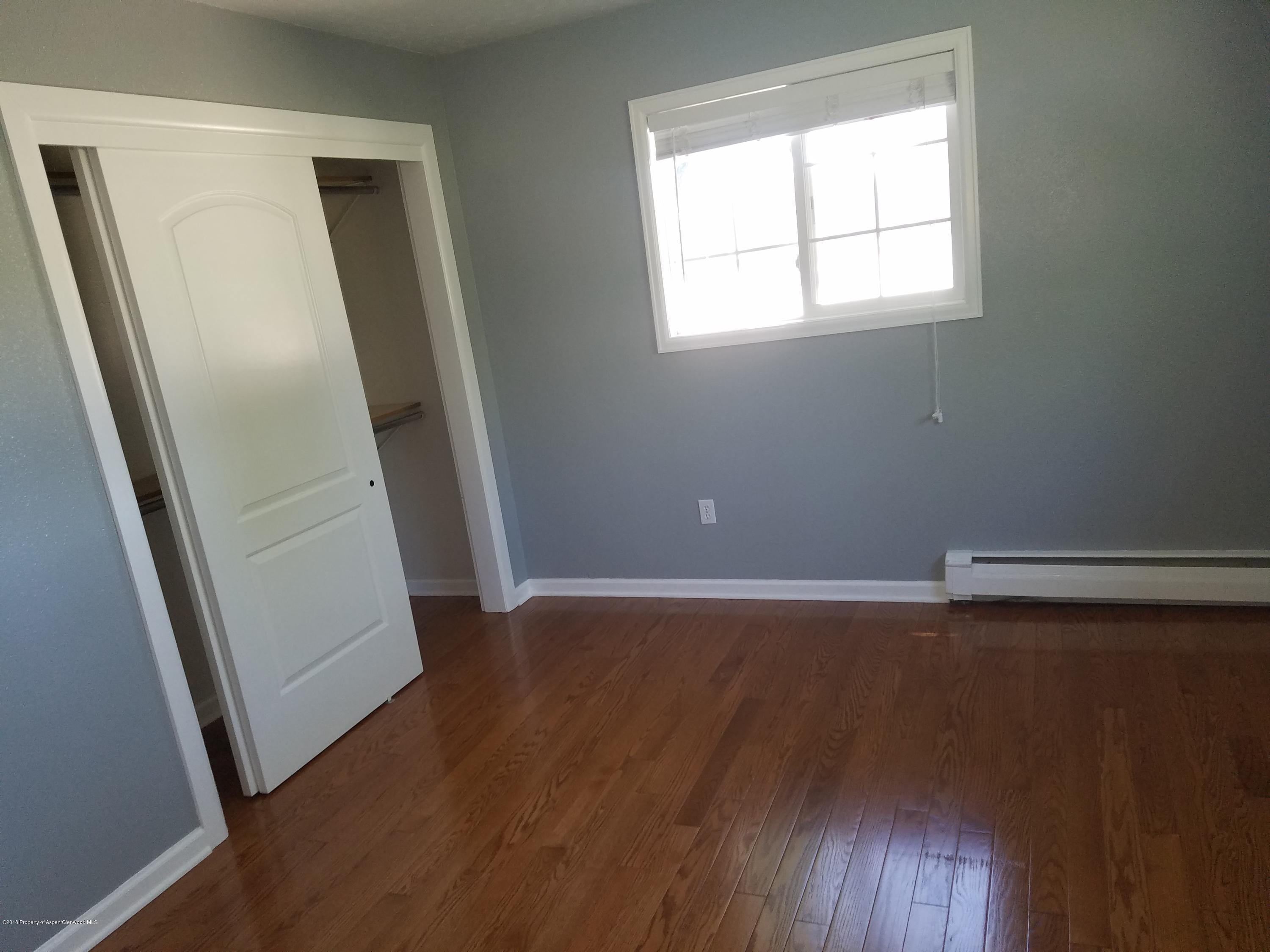 730 Green Street Craig, CO 81625 - Photo 15 of 34 an empty room with wooden floor and windows