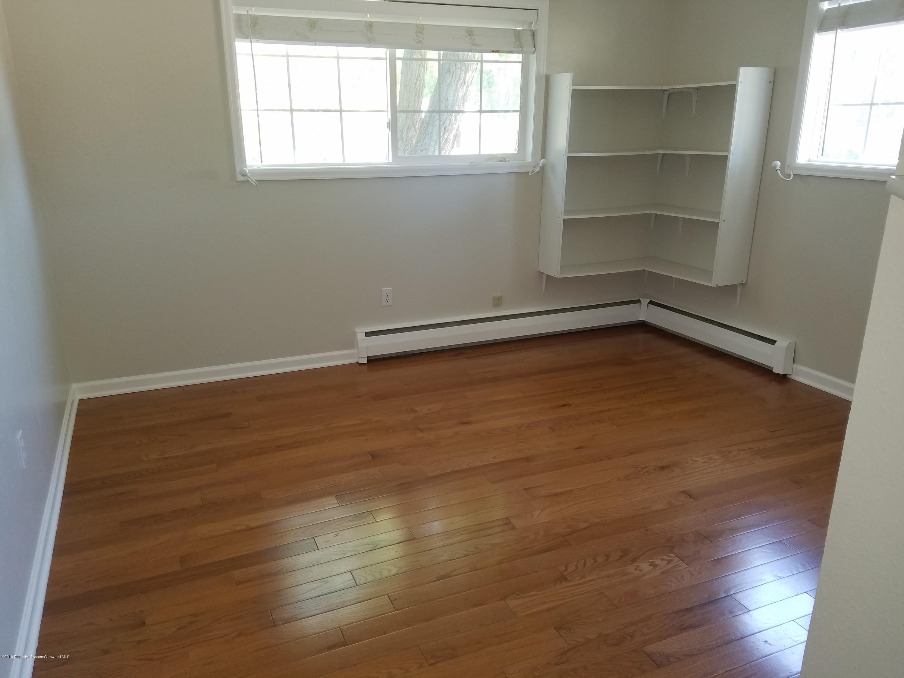 730 Green Street Craig, CO 81625 - Photo 17 of 34 a view of a room with wooden floor and window