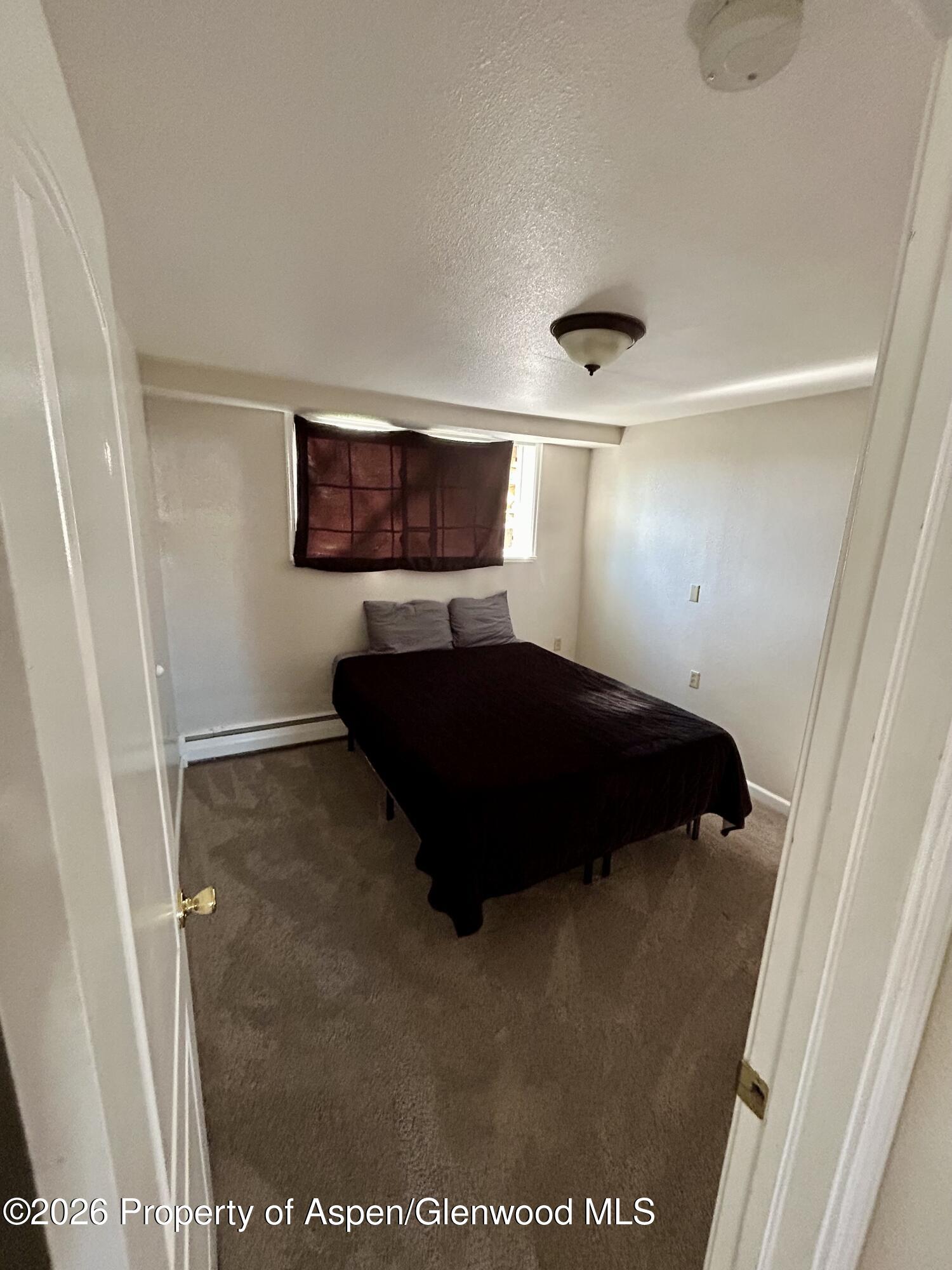 730 Green Street Craig, CO 81625 - Photo 26 of 34 a bedroom with a bed and a window